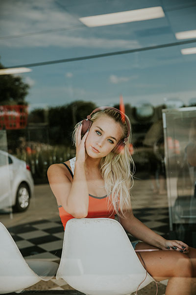 a girl with a headset by the window